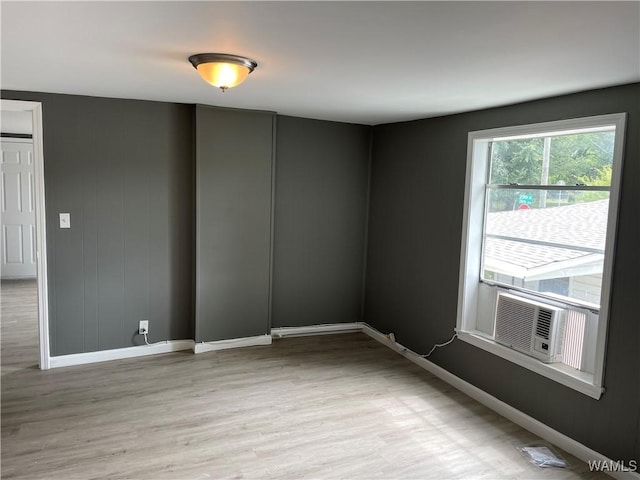 unfurnished room featuring light hardwood / wood-style floors and cooling unit