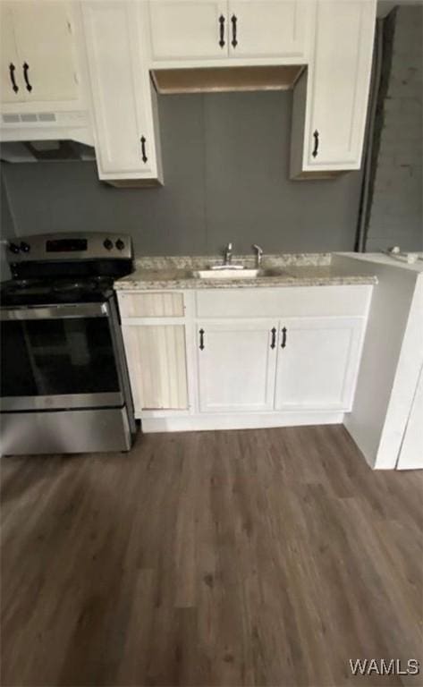 kitchen featuring dark hardwood / wood-style floors, white cabinetry, and stainless steel electric range oven