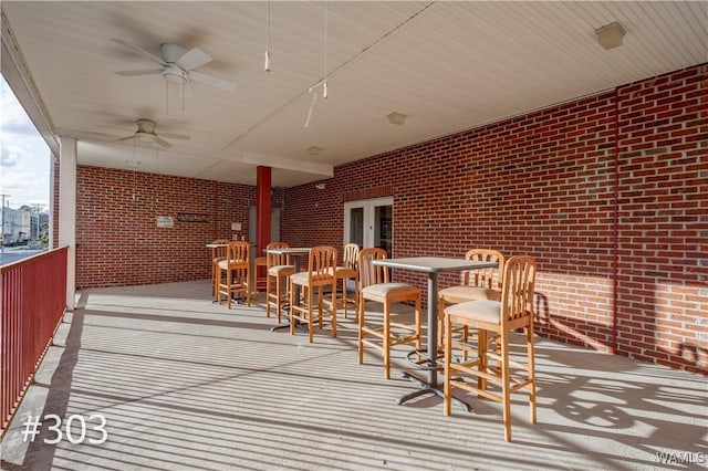 wooden terrace featuring ceiling fan