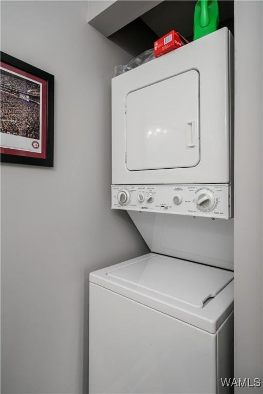 laundry room featuring stacked washer and clothes dryer