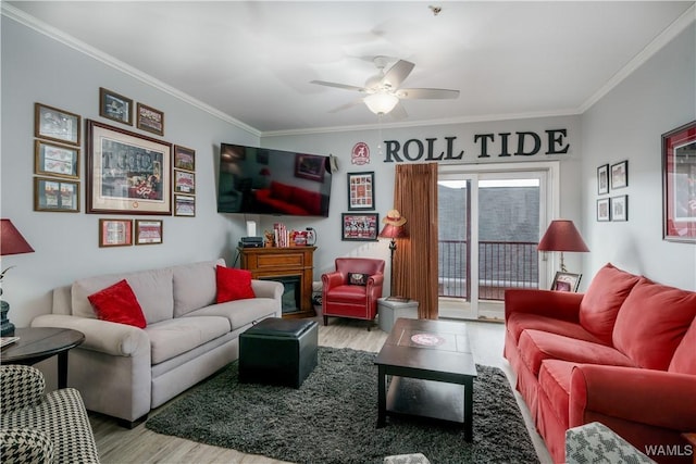 living room featuring a fireplace, light hardwood / wood-style floors, and ornamental molding