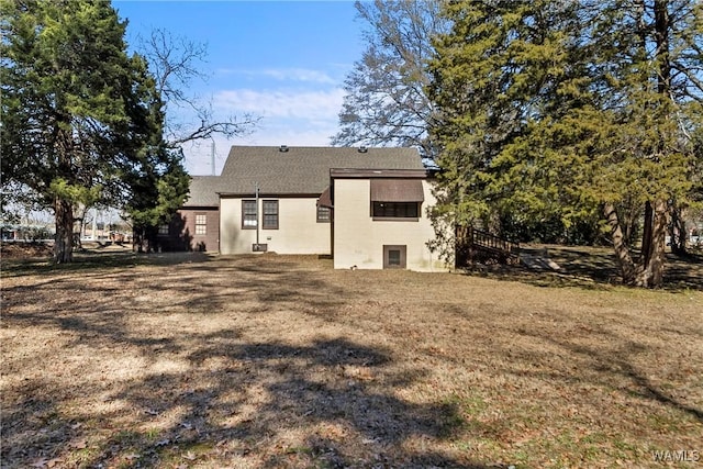 rear view of house featuring a lawn