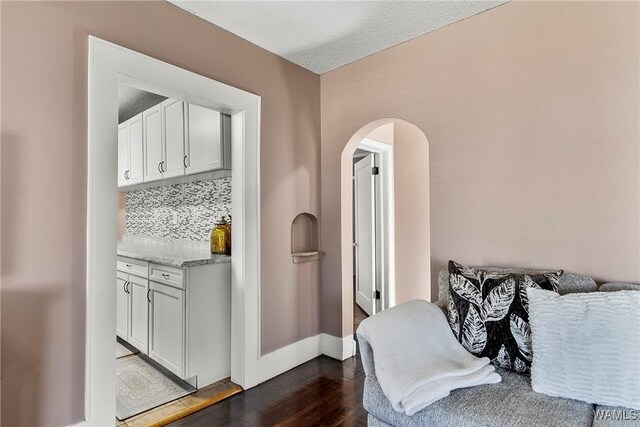 bedroom with wood-type flooring, separate washer and dryer, ceiling fan, crown molding, and a textured ceiling