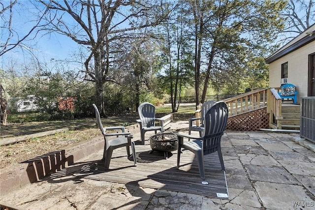 view of patio with a deck and an outdoor fire pit