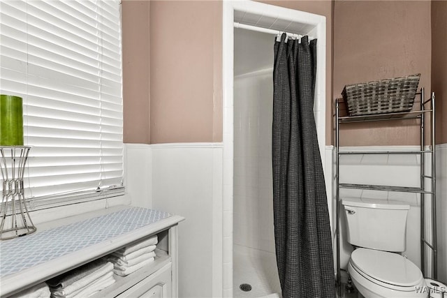 bathroom featuring curtained shower and toilet