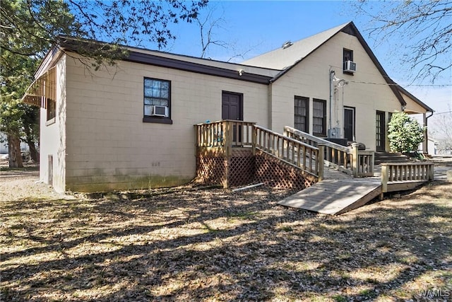 back of house featuring concrete block siding