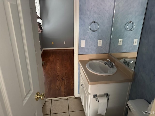 bathroom featuring toilet, vanity, and tile patterned floors