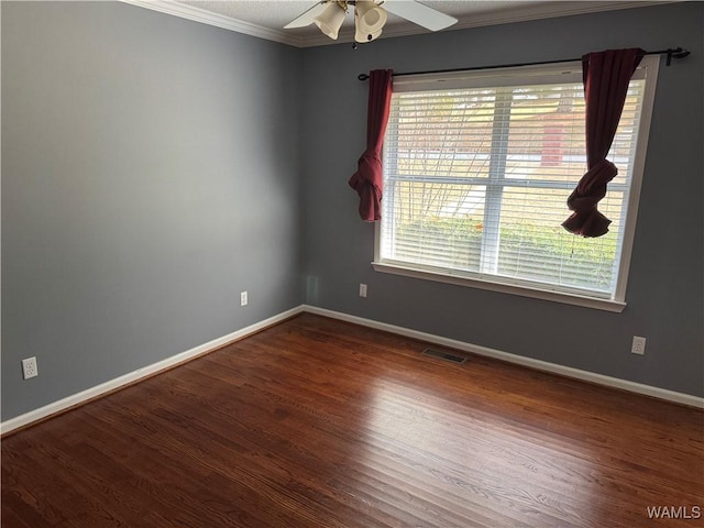 spare room with dark hardwood / wood-style flooring, ceiling fan, and crown molding