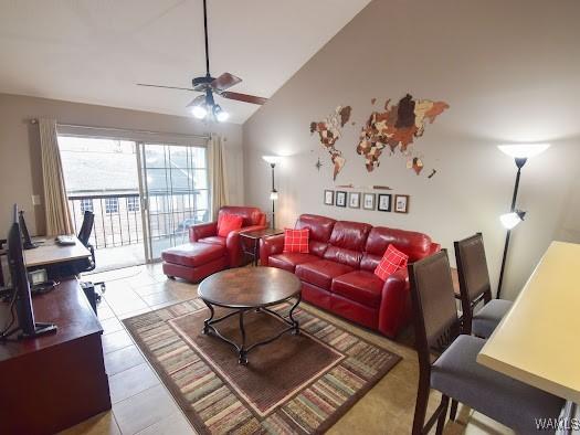 tiled living room featuring ceiling fan and high vaulted ceiling