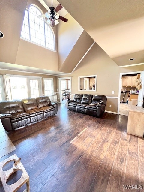 living room featuring hardwood / wood-style floors, high vaulted ceiling, and ceiling fan