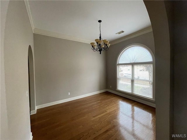 unfurnished room with dark wood-type flooring, visible vents, ornamental molding, and baseboards