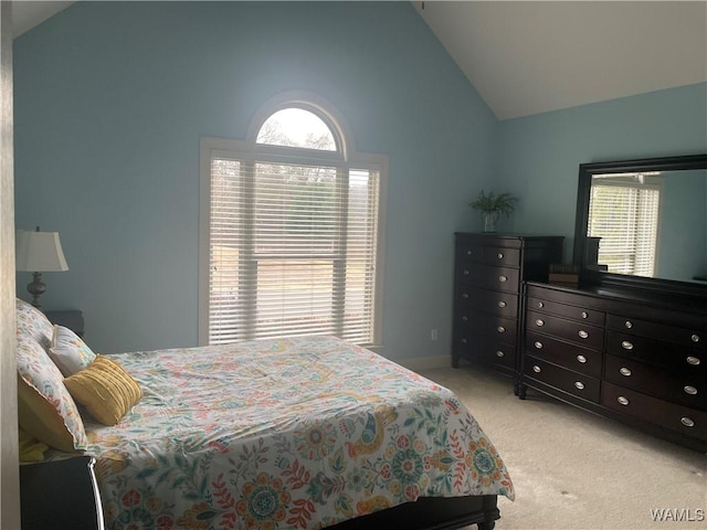 bedroom with light carpet and high vaulted ceiling