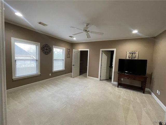 interior space featuring light colored carpet, visible vents, ornamental molding, ceiling fan, and baseboards