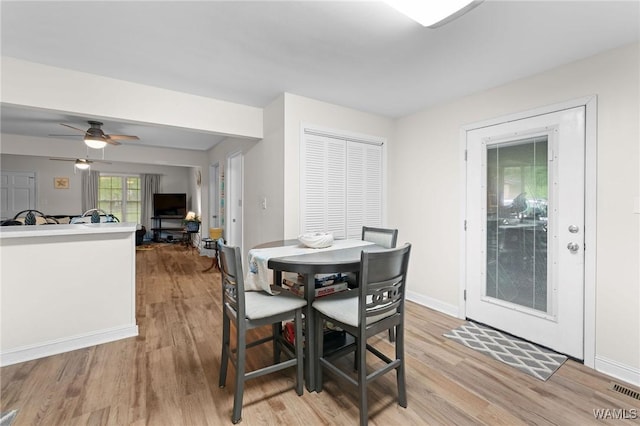12515 Bone Camp Rd, Northport, AL 35475 - dining area with light wood-type flooring, a ceiling fan, and baseboards