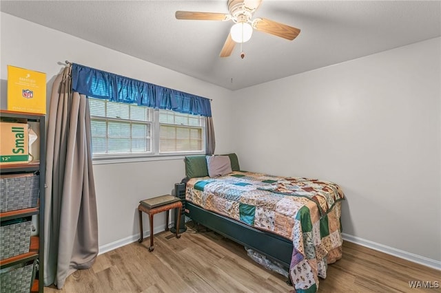12515 Bone Camp Rd, Northport, AL 35475 - bedroom with wood finished floors, baseboards, and ceiling fan
