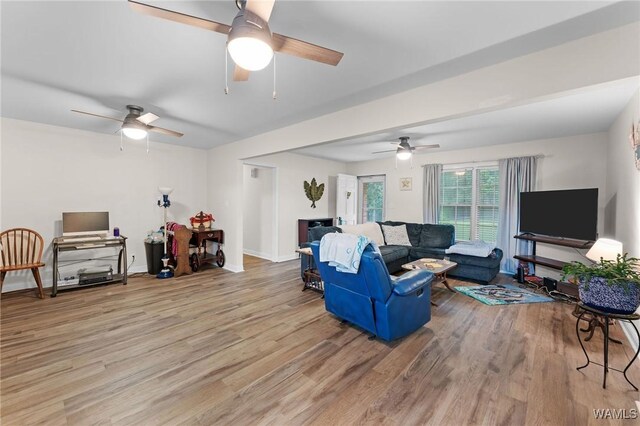 12515 Bone Camp Rd, Northport, AL 35475 - living room featuring a ceiling fan, light wood-type flooring, and baseboards