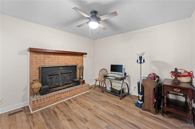 12515 Bone Camp Rd, Northport, AL 35475 - home office with wood finished floors, a ceiling fan, a fireplace, and baseboards
