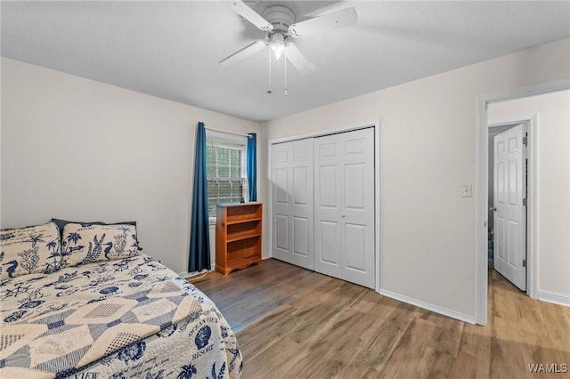 12515 Bone Camp Rd, Northport, AL 35475 - bedroom with wood finished floors, a closet, ceiling fan, and baseboards