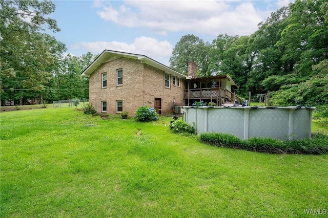 12515 Bone Camp Rd, Northport, AL 35475 - back of property featuring a chimney, a yard, brick siding, and an outdoor pool