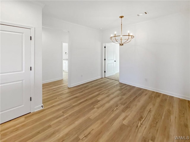 unfurnished dining area featuring baseboards, a notable chandelier, visible vents, and light wood-style flooring