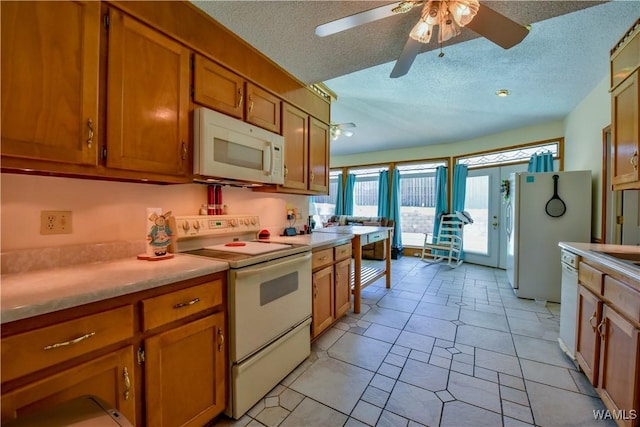 3541 Oak Bend Rd, Tuscaloosa, AL 35406 - kitchen with white appliances, a textured ceiling, brown cabinetry, ceiling fan, and light countertops