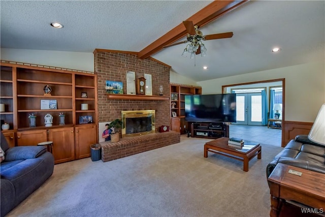 3541 Oak Bend Rd, Tuscaloosa, AL 35406 - living area featuring carpet flooring, a wainscoted wall, ceiling fan, a textured ceiling, and a fireplace