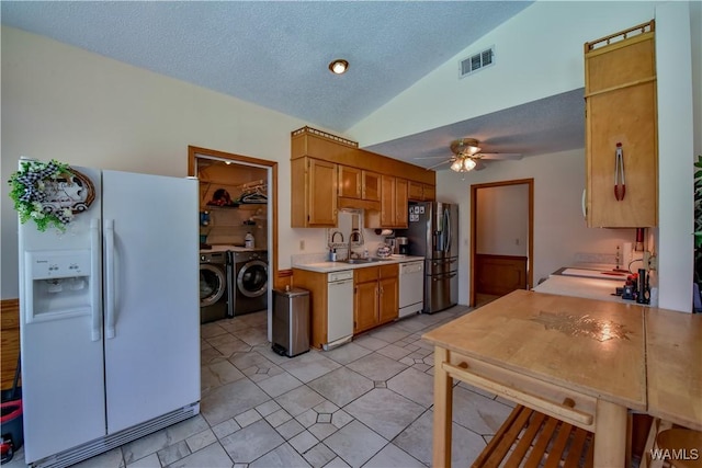 3541 Oak Bend Rd, Tuscaloosa, AL 35406 - kitchen featuring white appliances, washing machine and clothes dryer, light countertops, ceiling fan, and vaulted ceiling