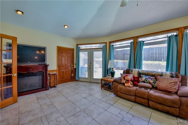 3541 Oak Bend Rd, Tuscaloosa, AL 35406 - living room with lofted ceiling, french doors, a glass covered fireplace, and a wainscoted wall