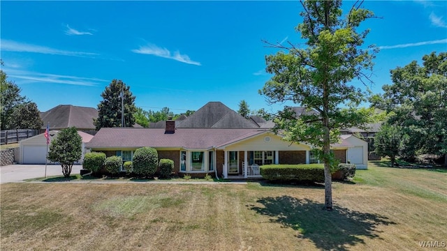 3541 Oak Bend Rd, Tuscaloosa, AL 35406 - ranch-style home featuring a front lawn, covered porch, a chimney, and a garage