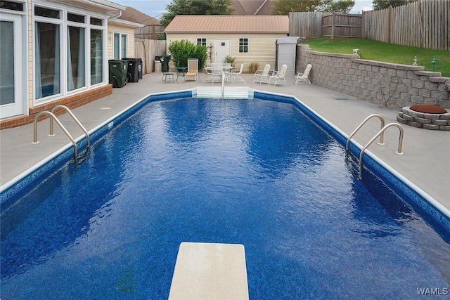 3541 Oak Bend Rd, Tuscaloosa, AL 35406 - view of swimming pool featuring a patio area, a diving board, a fenced backyard, an outdoor fire pit, and an outdoor structure