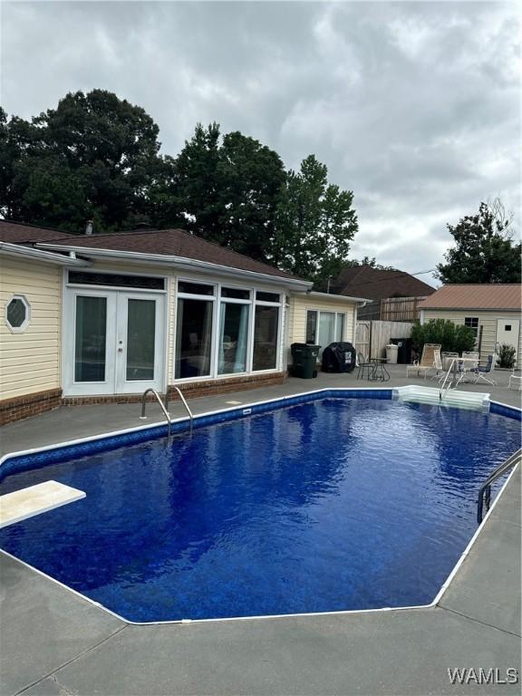 3541 Oak Bend Rd, Tuscaloosa, AL 35406 - view of pool featuring a patio, a diving board, an outdoor structure, and french doors