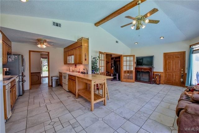 3541 Oak Bend Rd, Tuscaloosa, AL 35406 - kitchen with white appliances, a ceiling fan, open floor plan, light countertops, and a wainscoted wall