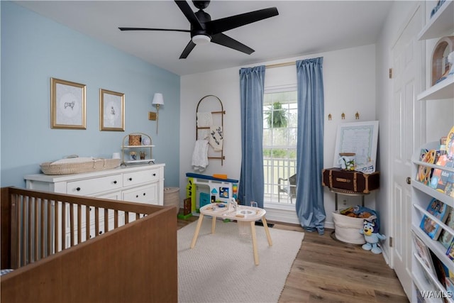 bedroom with access to outside, wood finished floors, and ceiling fan