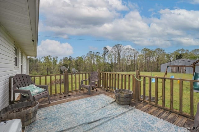deck with a playground and a lawn