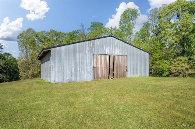 view of pole building with a yard