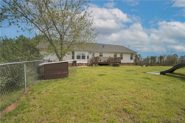 view of yard featuring fence and a deck