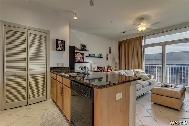 kitchen featuring light tile patterned flooring, sink, black dishwasher, kitchen peninsula, and dark stone counters