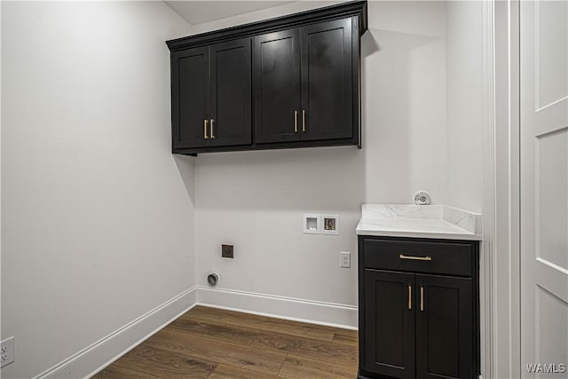 clothes washing area with dark wood-type flooring, cabinets, hookup for a washing machine, and electric dryer hookup