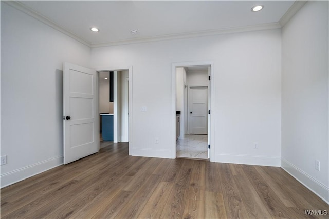 unfurnished bedroom with crown molding and hardwood / wood-style floors