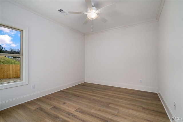 spare room featuring hardwood / wood-style flooring, ceiling fan, and ornamental molding