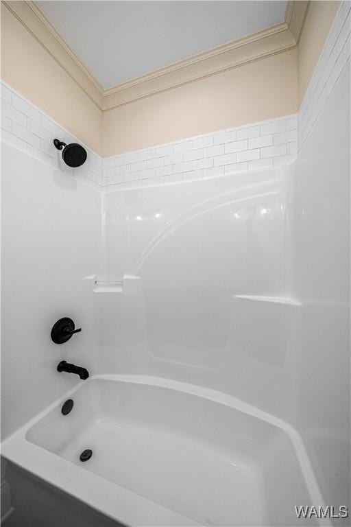 bathroom featuring ornamental molding and tub / shower combination