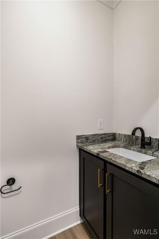 bathroom with vanity and hardwood / wood-style floors