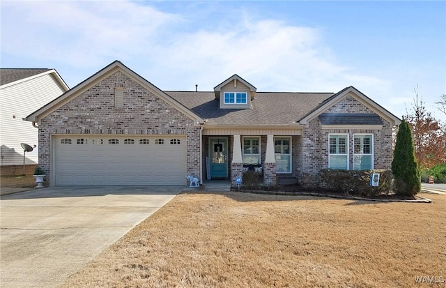 view of front of home featuring driveway, brick siding, a garage, and a front yard