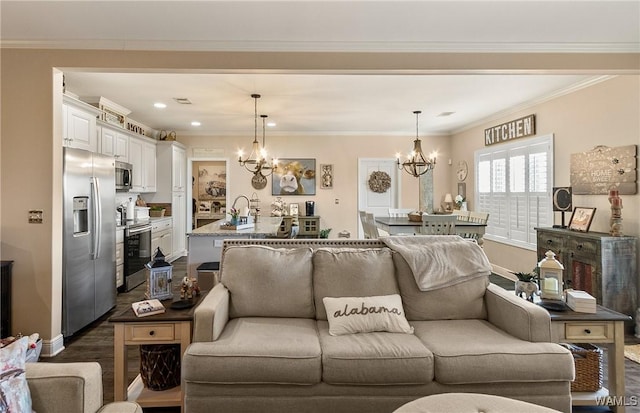 living area with a notable chandelier, dark wood-style flooring, visible vents, baseboards, and crown molding