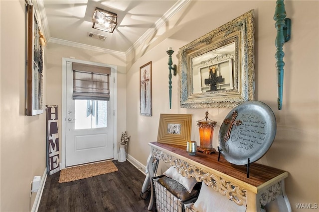 doorway to outside with ornamental molding, dark wood-style flooring, visible vents, and baseboards