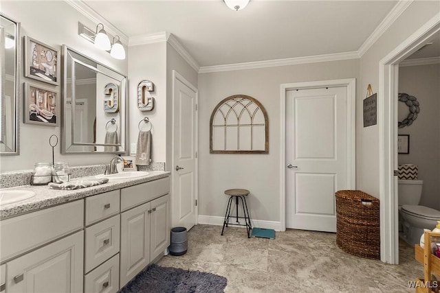 bathroom featuring double vanity, ornamental molding, a sink, and toilet