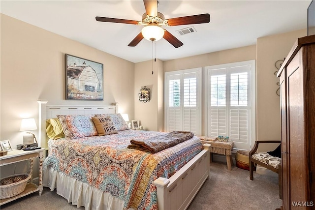 carpeted bedroom featuring visible vents and ceiling fan