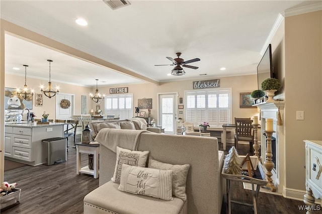 living area featuring visible vents, dark wood finished floors, and crown molding