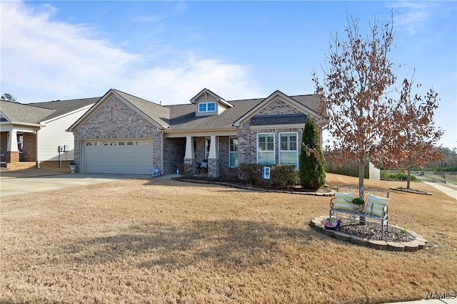 view of front of property featuring a garage, driveway, brick siding, and a front lawn