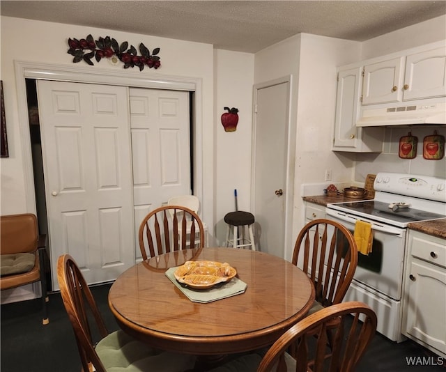 dining space featuring a textured ceiling